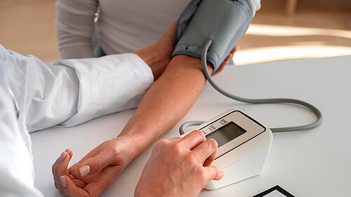 Photo of someone having their blood pressure tested