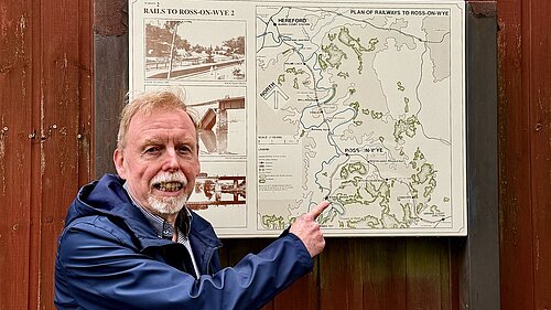 Photo of a man pointing at a map of the old Hereford to Gloucester railway line
