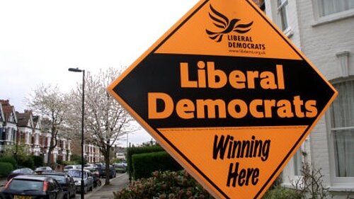 Photo of a stakeboard outside a house. Stakeboard reads "Liberal Democrats winning here"